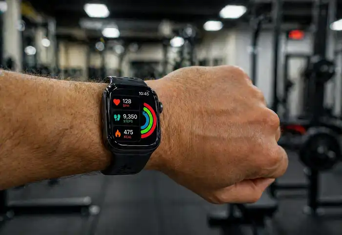 smartwatch on man wrist showing health stats