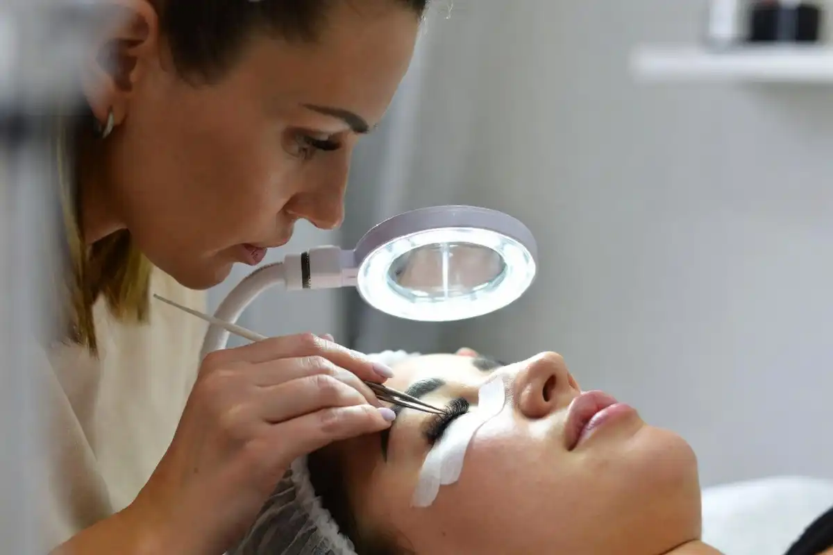 Professional lash tech near me applying eyelash extensions in a clean salon setting