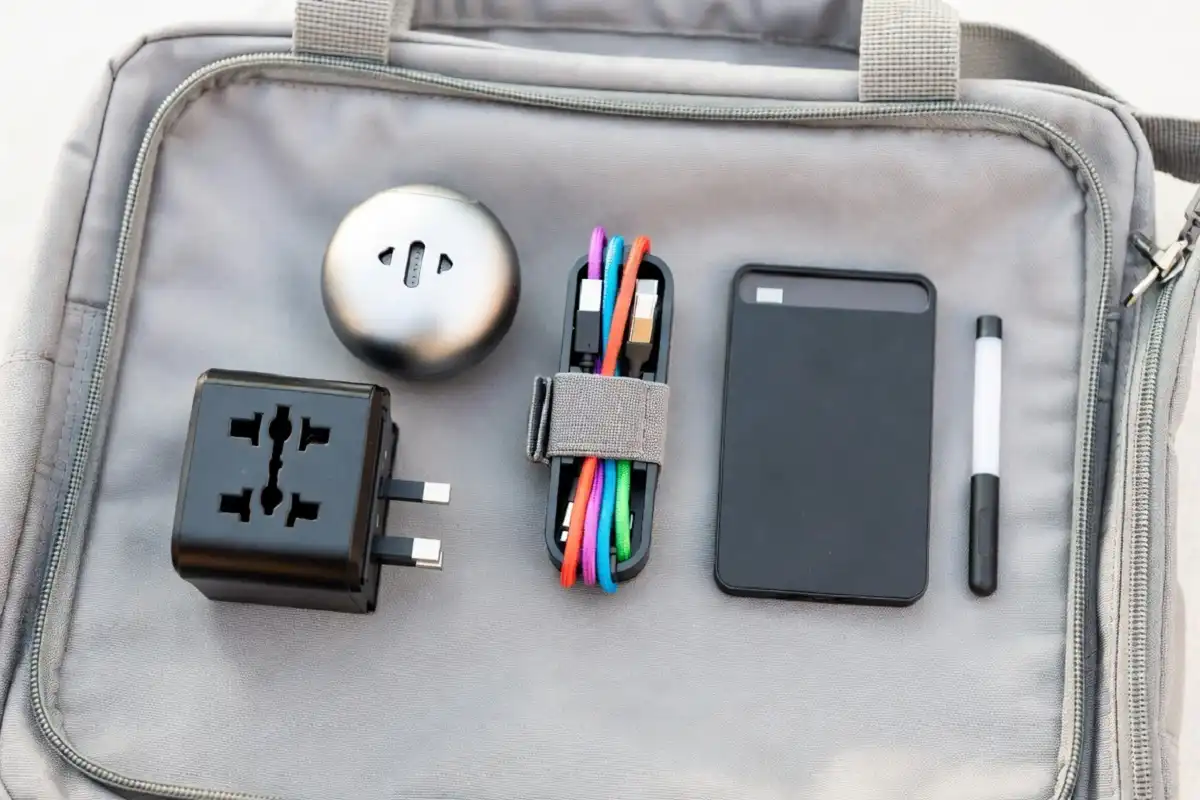 mall gadgets for travel including adapter, Bluetooth speaker, cable organizer, and portable SSD