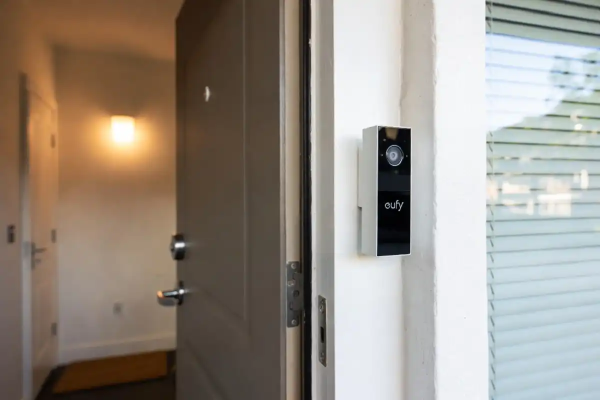Smart video doorbell and smoke detector electronics gadgets installed at home entrance
