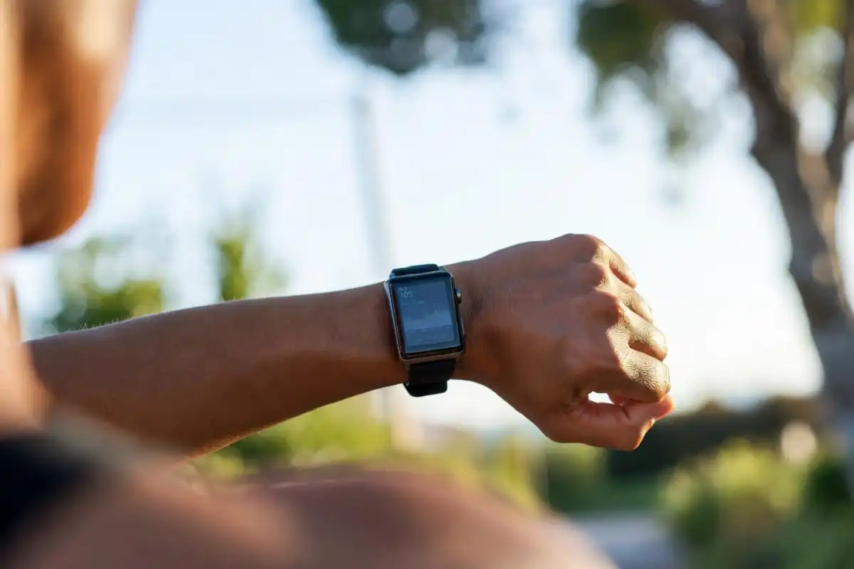 Person wearing a smartwatch tracking heart rate during an outdoor run