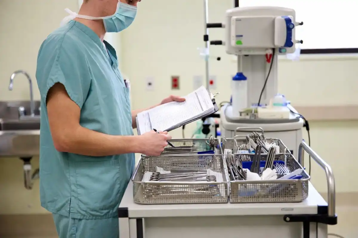 Surgical tech reviewing pre-op checklist as part of surgical tech jobs responsibilities