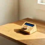 A timber tech wooden smart home device on a natural wood desk