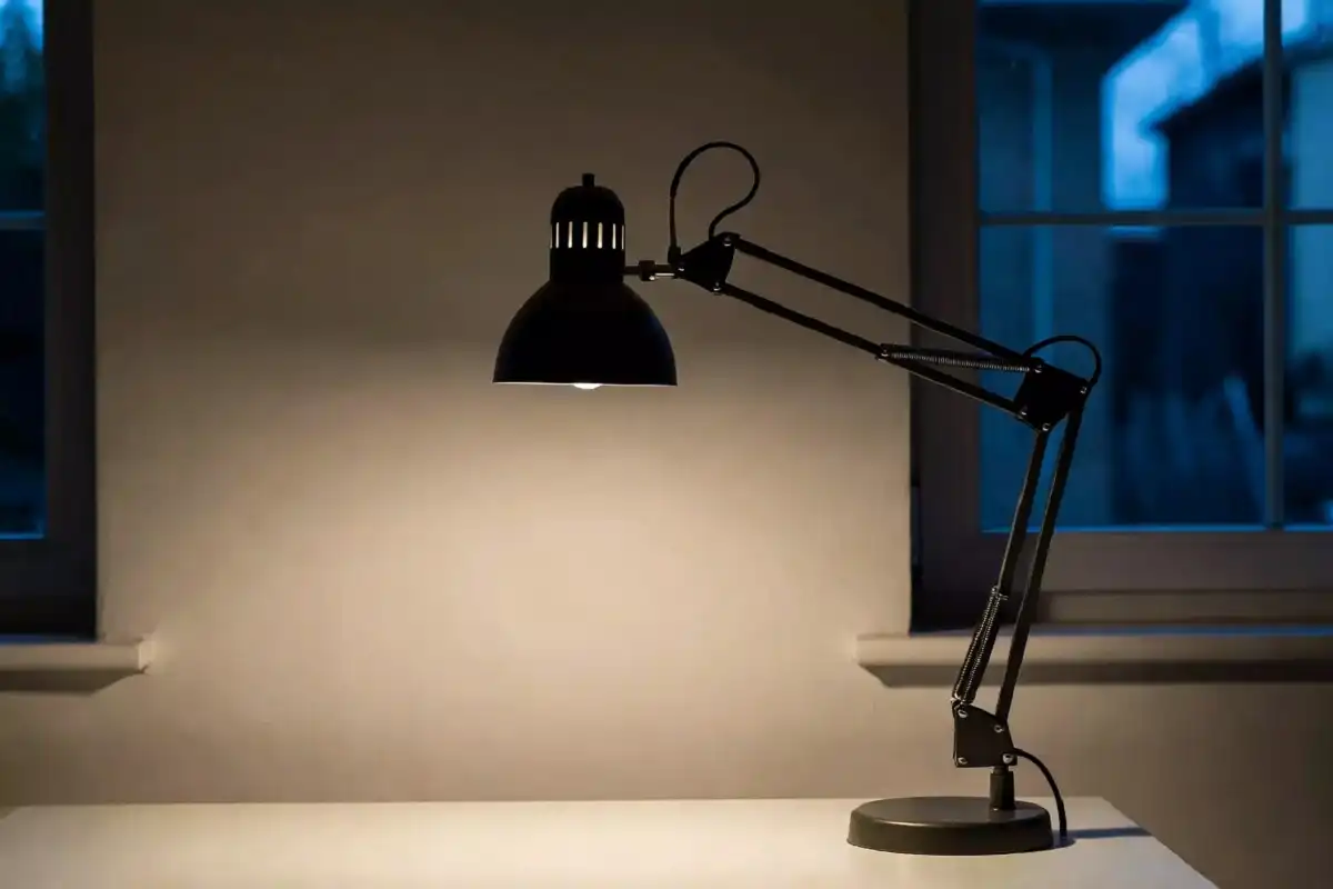 Adjustable desk lamp providing lighting for a men's office setup