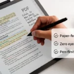 Person using an e ink tablet for PDF annotation with handwritten notes and highlights on screen